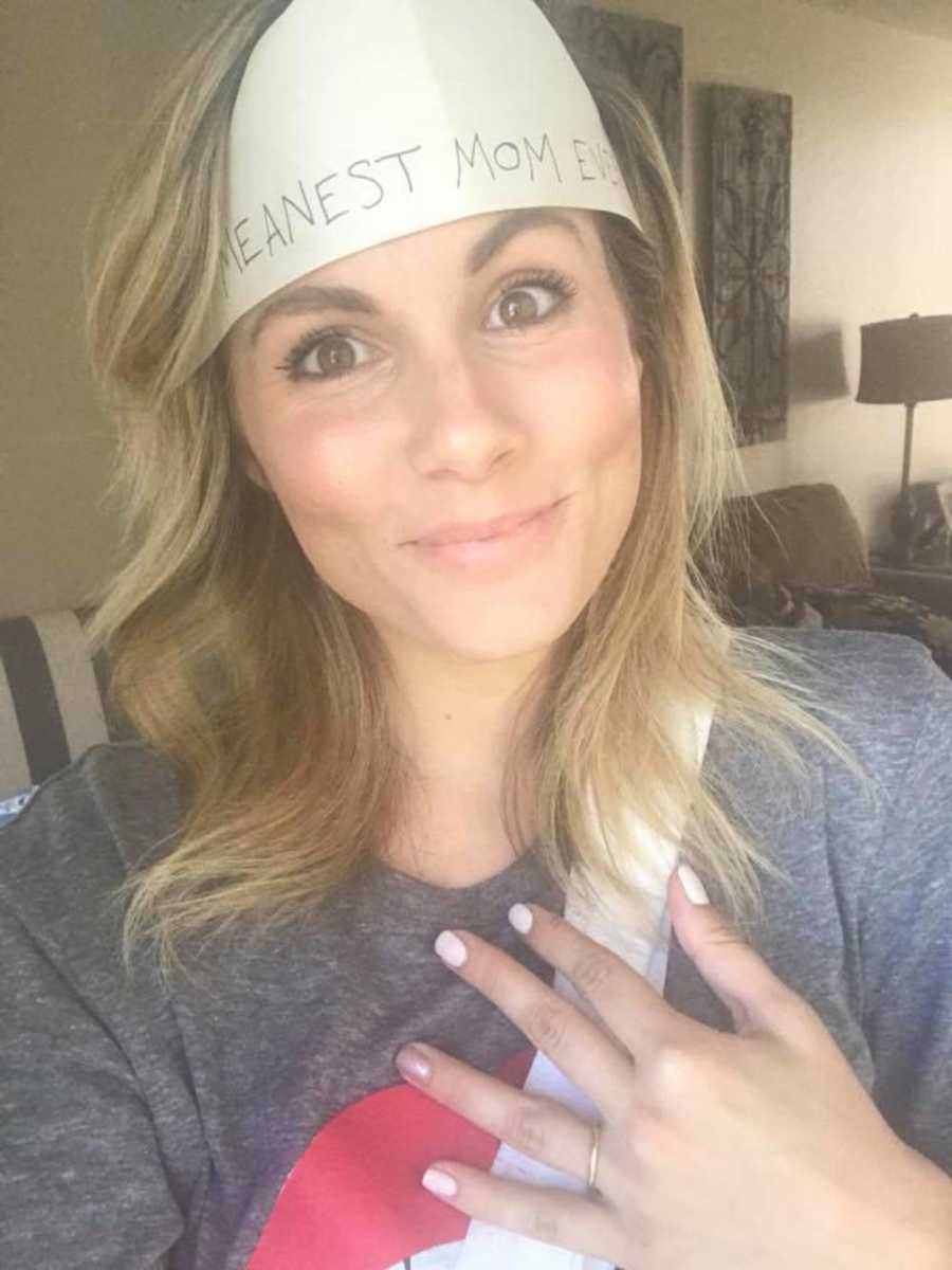 Mother smiling in selfie wearing bandana that says, "Meanest Mom Ever"