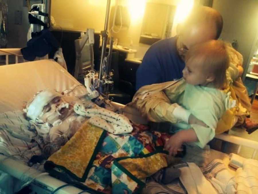 Baby lying in emergency room with father and older sister standing beside him