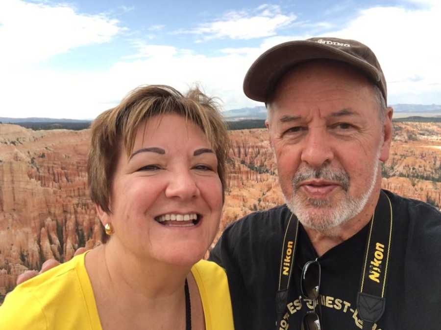 Man with cancer smiles beside wife at Grand Canyon