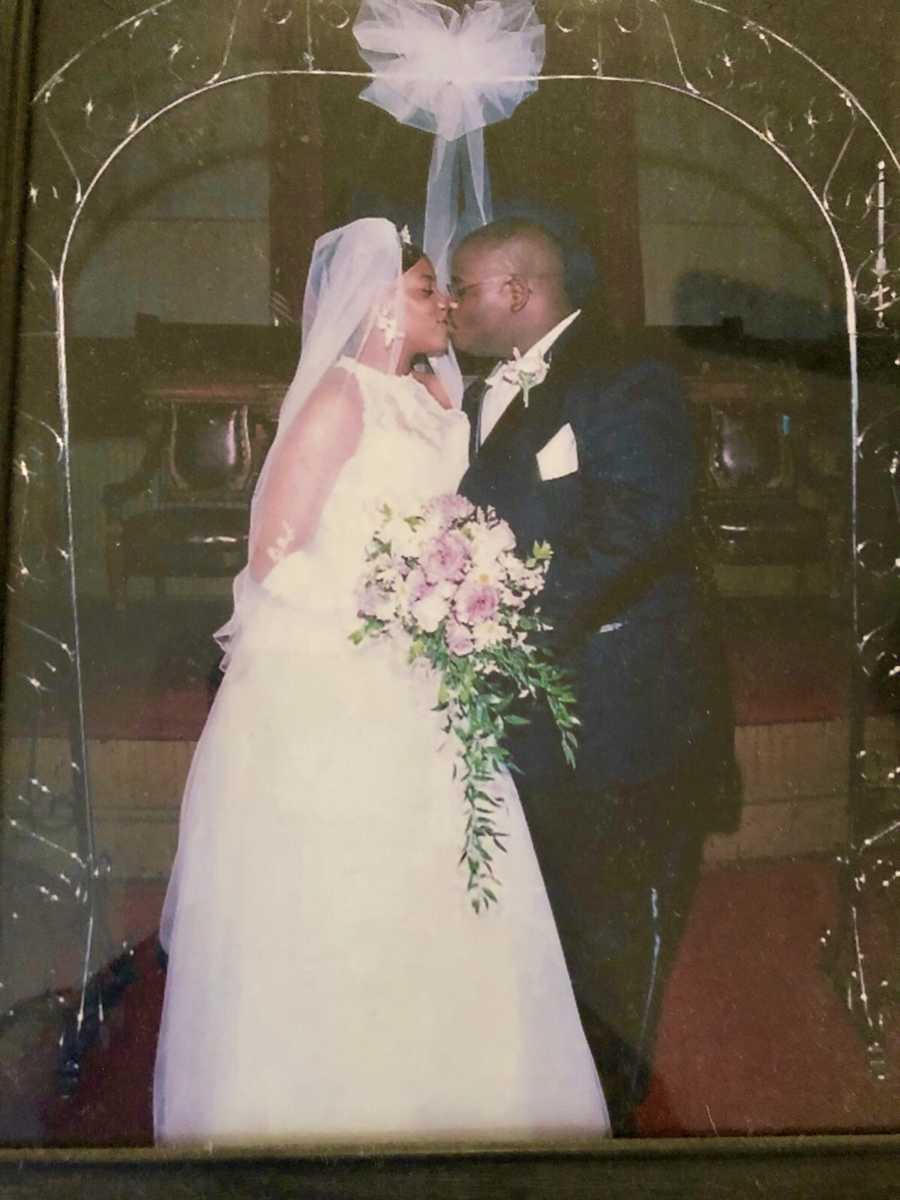 Couple whose child was a still born kissing at the altar on their wedding day