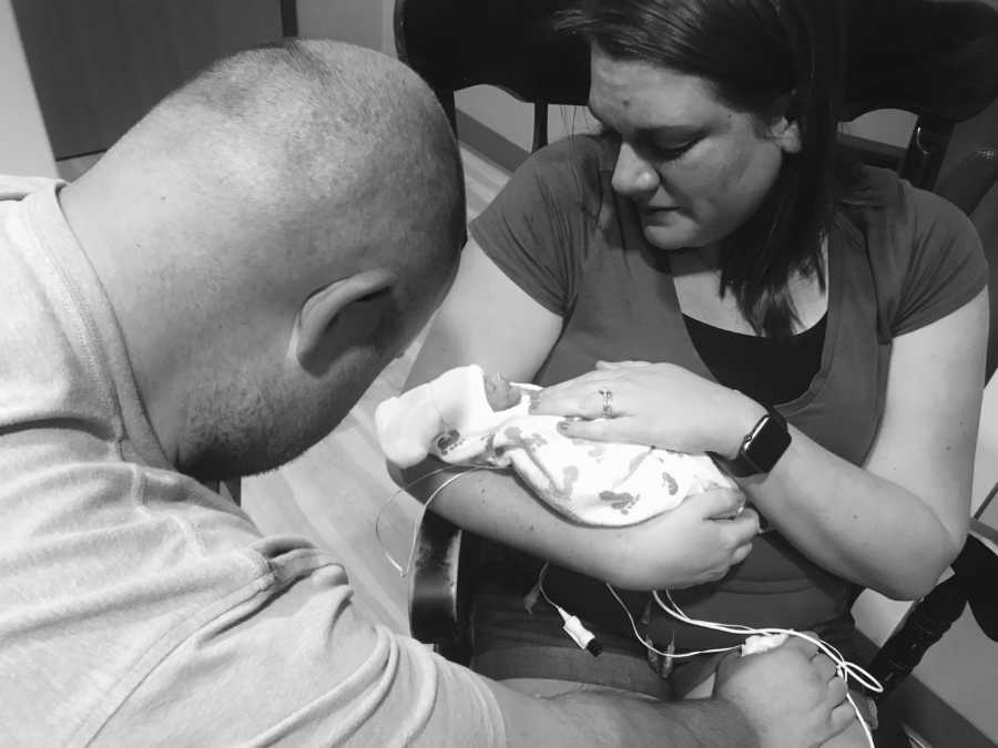 Mother holds micro preemie in her arms as she and her husband say goodbye to her