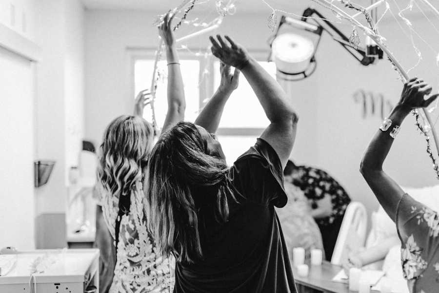 Nurse and other women throwing confetti into the air in celebration of 19 year old with cancer's marriage