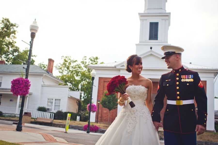 Bride and soldier groom hold hands outside of church
