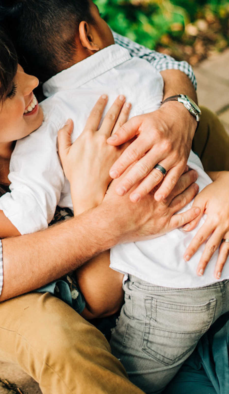 Close up of adopted son hugging mother and father