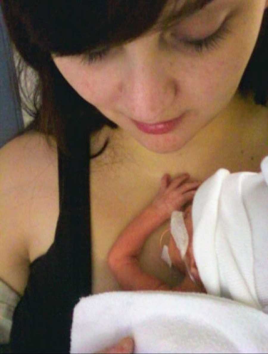 Woman who had HELLP Syndrome looks down at newborn who is laying on her chest