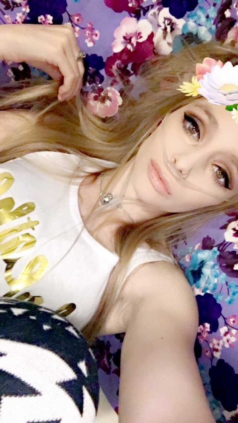 Woman with cystic fibrosis takes selfie with flower crown filter