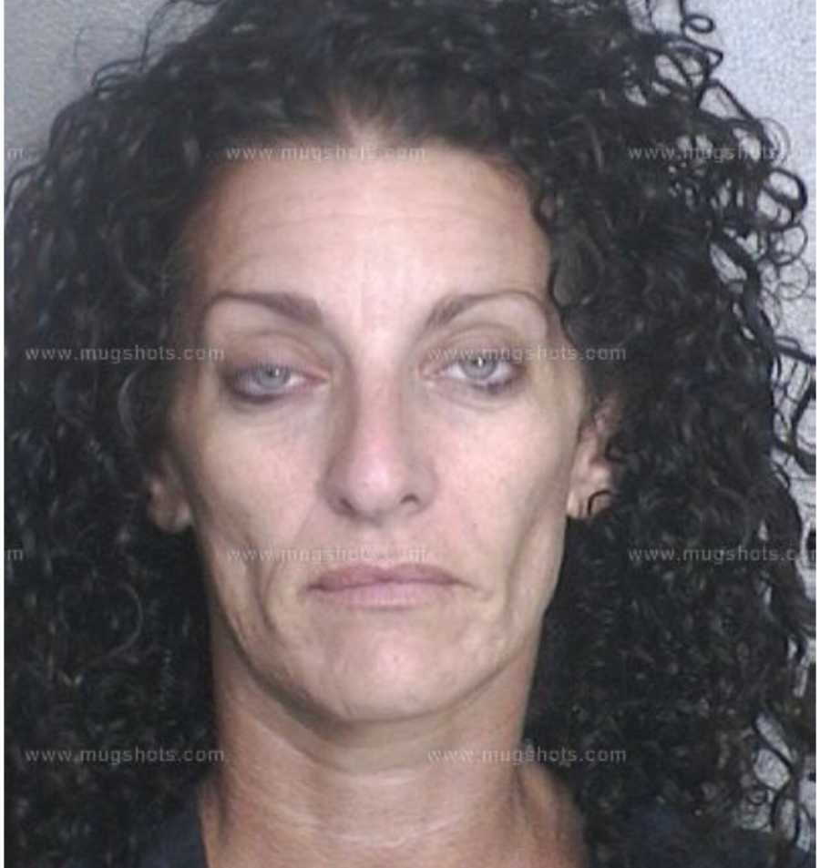 Mugshot of woman with black curly hair who was arrested for use of drugs
