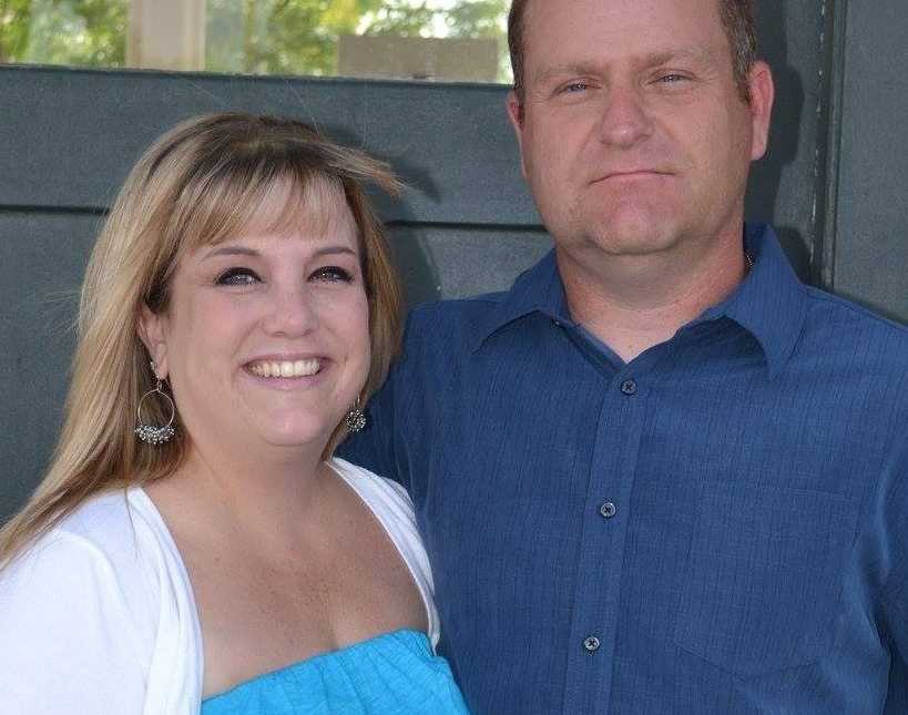 Woman stands beside deceased husband who had pancreatic cancer