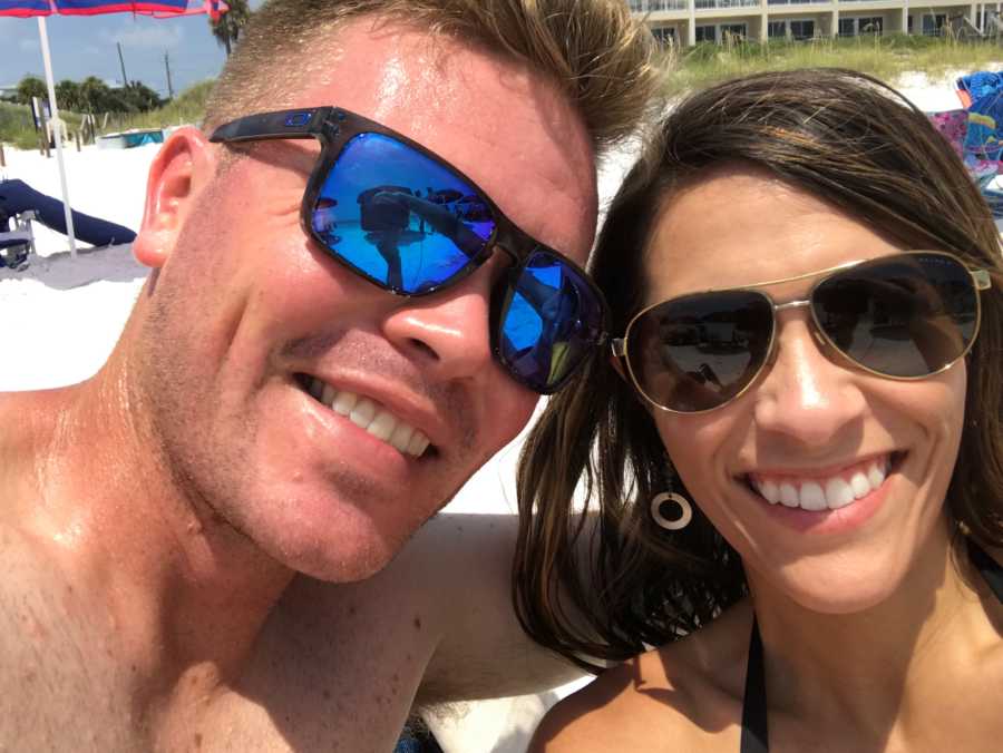 Husband and wife who experienced love at first sight smile in selfie on beach