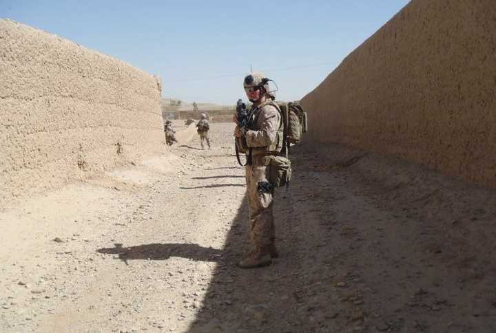 Soldier standing in dirt pit in uniform who fell in love with a woman the minute he saw her