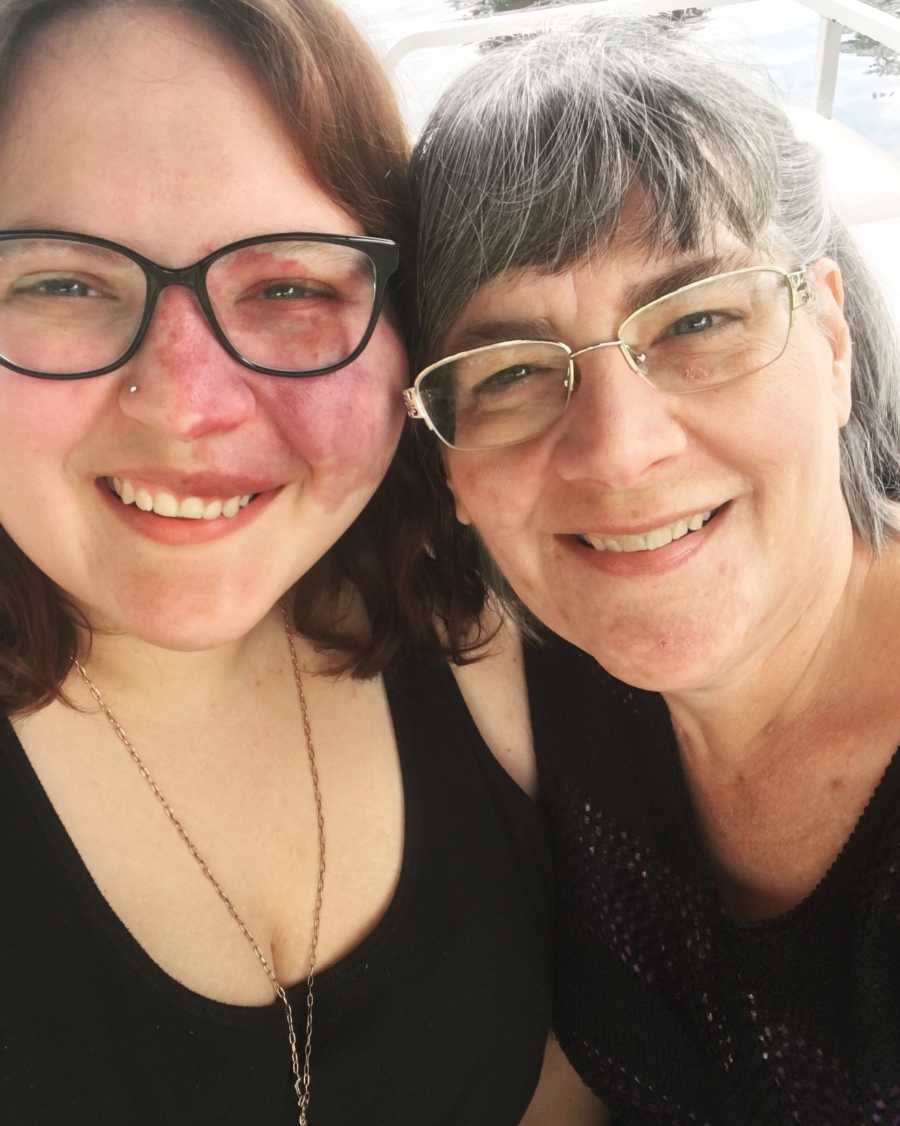 Mother smiles in selfie with her engaged daughter