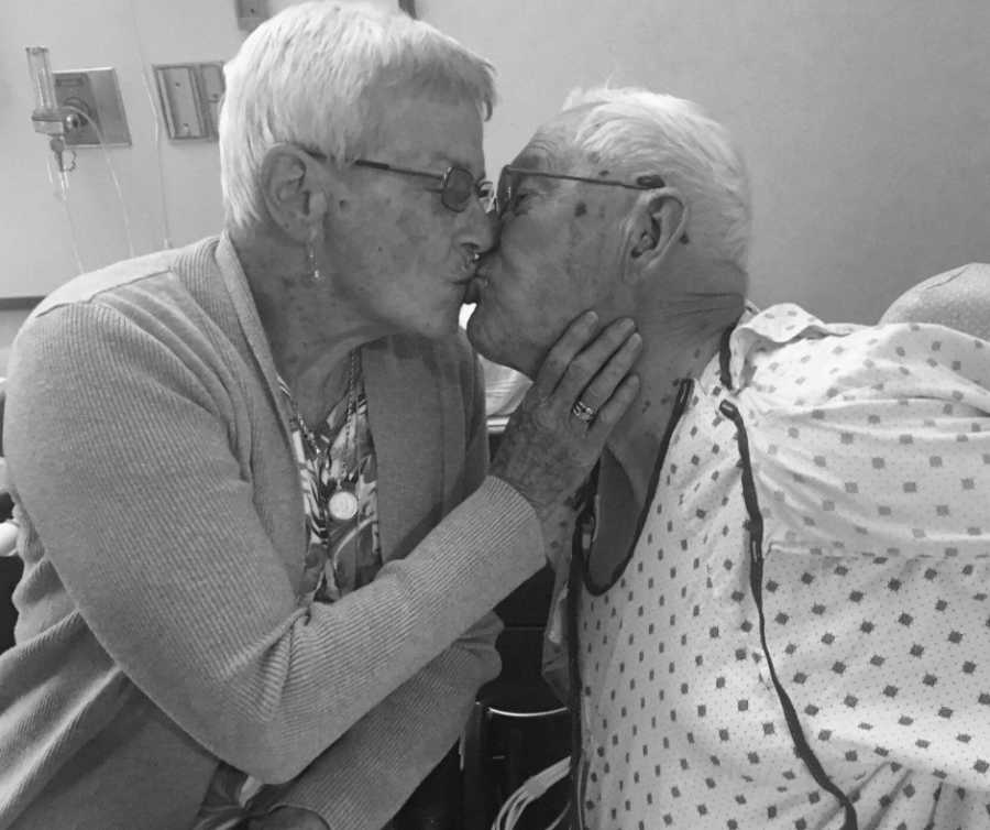 Elderly man who just had surgery kisses wife who has dementia