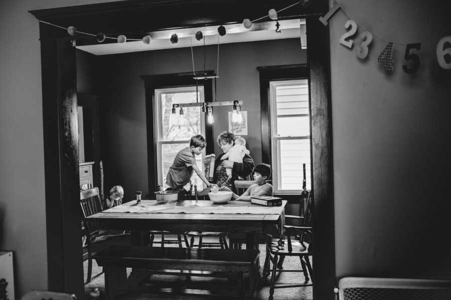 View from a far of foster kids sitting at dining room table