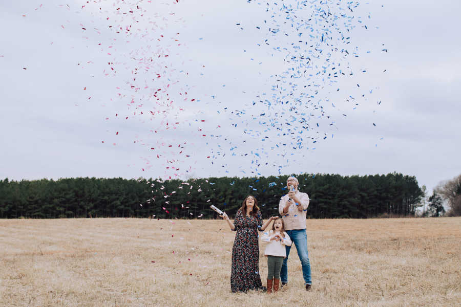 Husband and wife who struggled with fertility pop confetti cannons for gender reveal with daughter