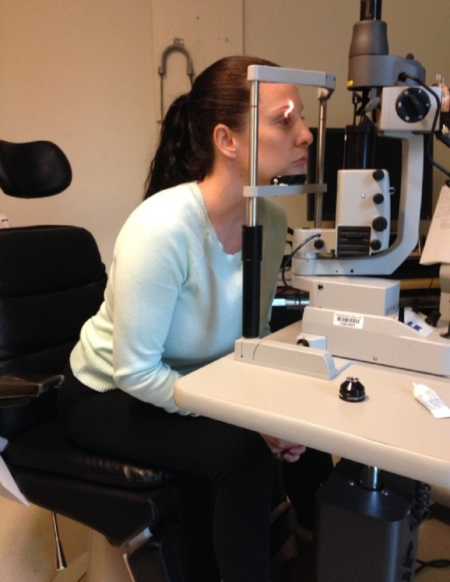 Woman with POTS Disease sits looking into eye testing machine