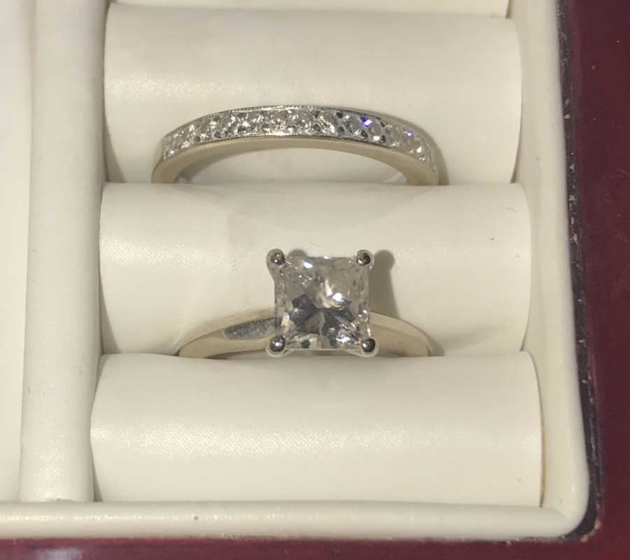 Close up of ring box with engagement ring and wedding band