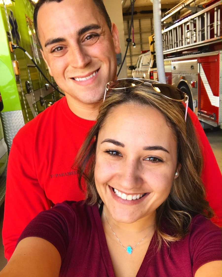 Wife who battles infertility smiles in selfie with firefighter husband behind her