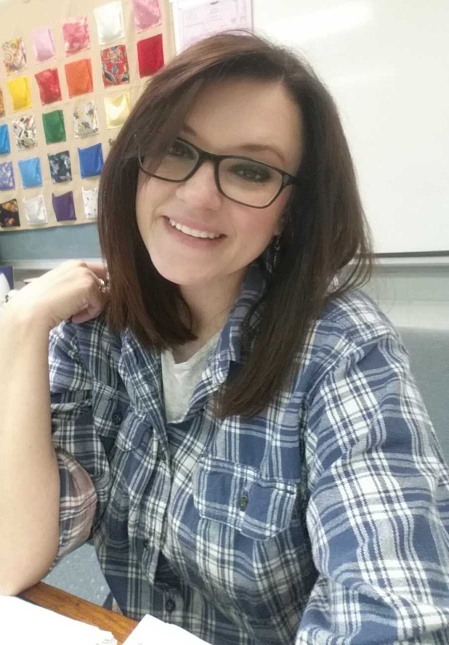 Mother who feels as though she needs to defend herself for not quitting her job smile in selfie in her classroom
