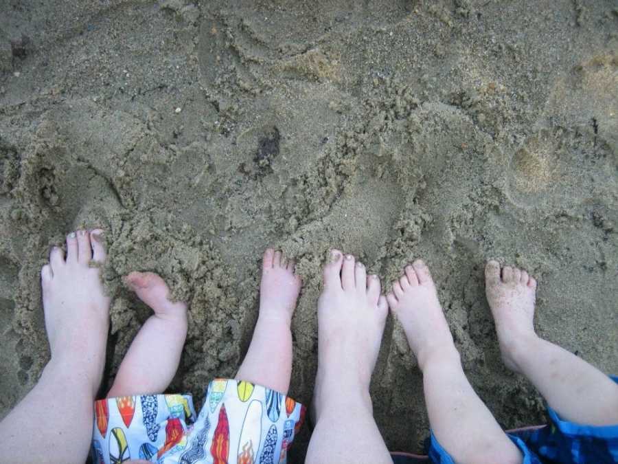 Mother's feet in the sand beside children's feet who have grown up faster than expected