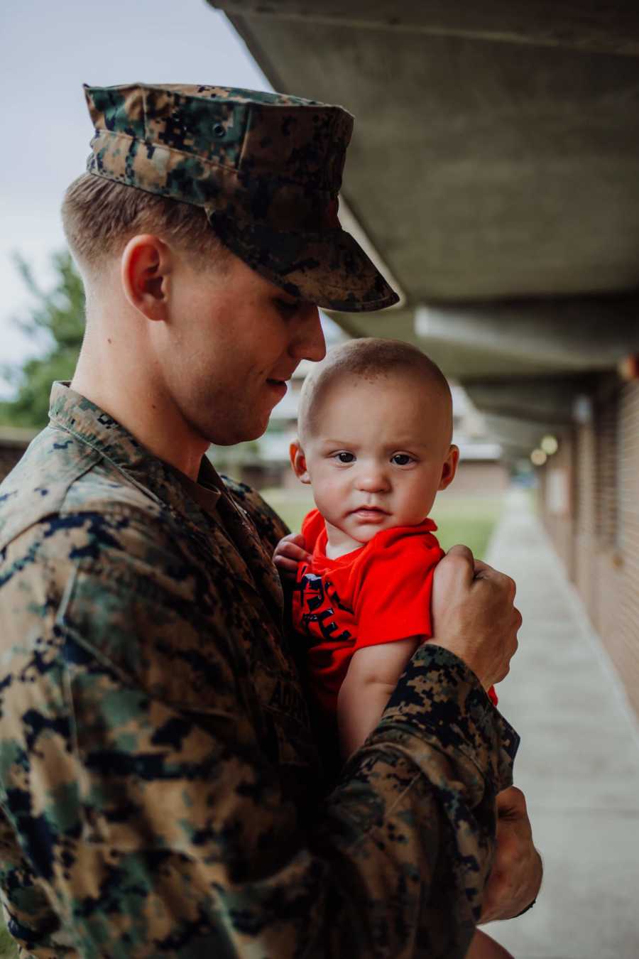 Army father holds infant son at his return from deployment