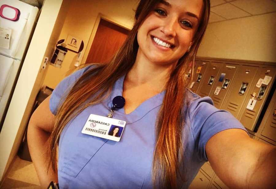 Mentor to pregnant woman who abuse drugs smiles in selfie wearing scrubs