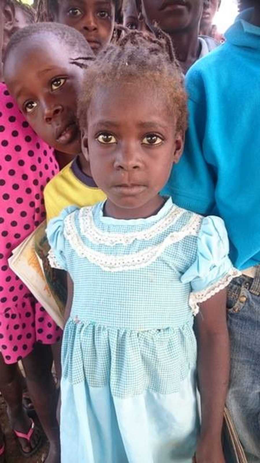 Close up of little girl who is an orphan in Haiti who looks sad