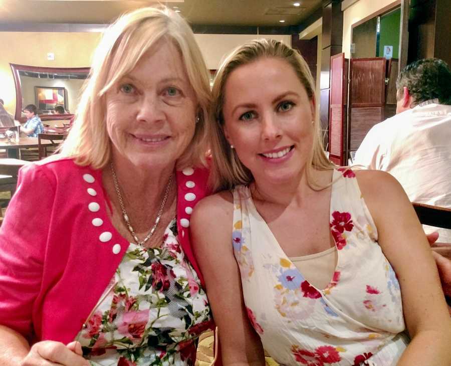 Woman who was teen mother sits beside her mother at restaurant smiling