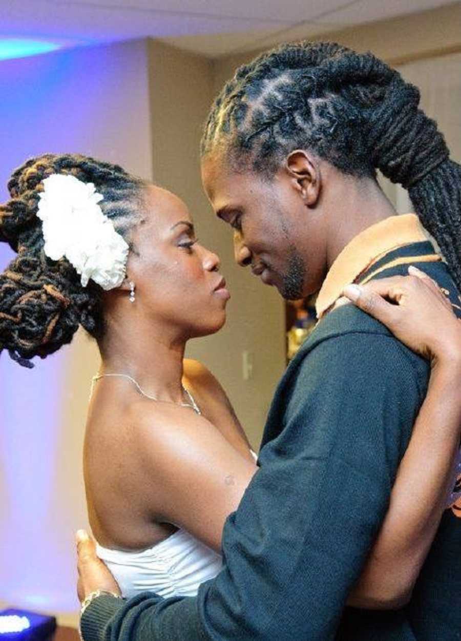 Bride and groom stand closely dancing at their wedding