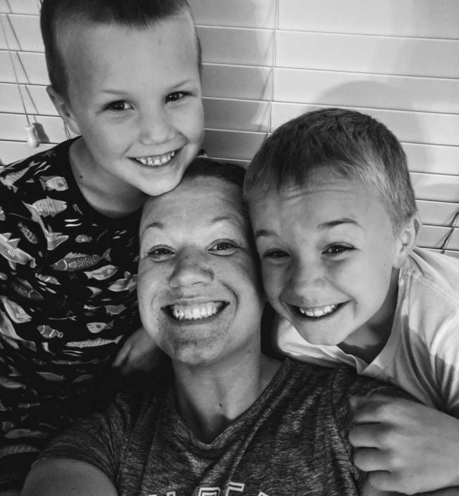 Mother who was bullied in school smiles in selfie with two young sons