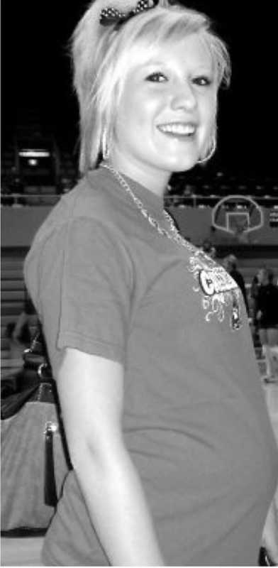 Pregnant teen smiling in school gymnasium