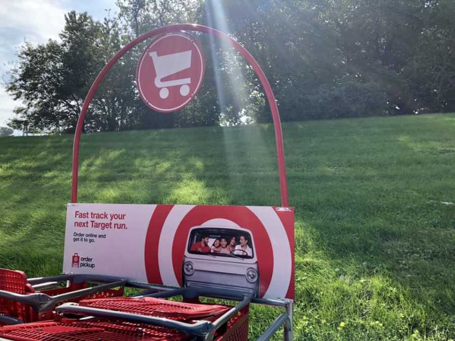 Target shopping cart return with grass and trees in background