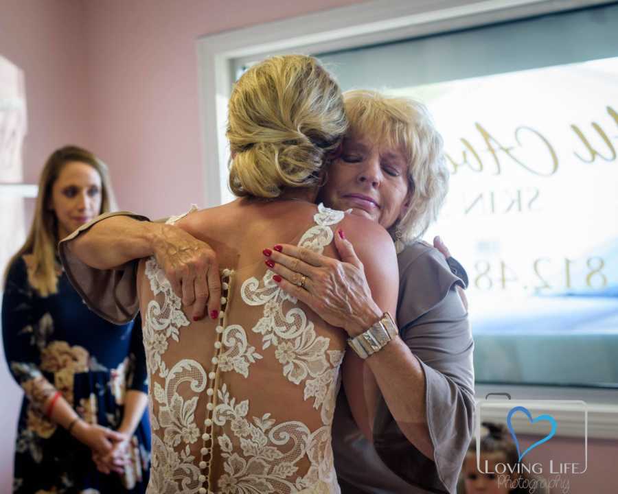 Bride hugs mother on her wedding day 