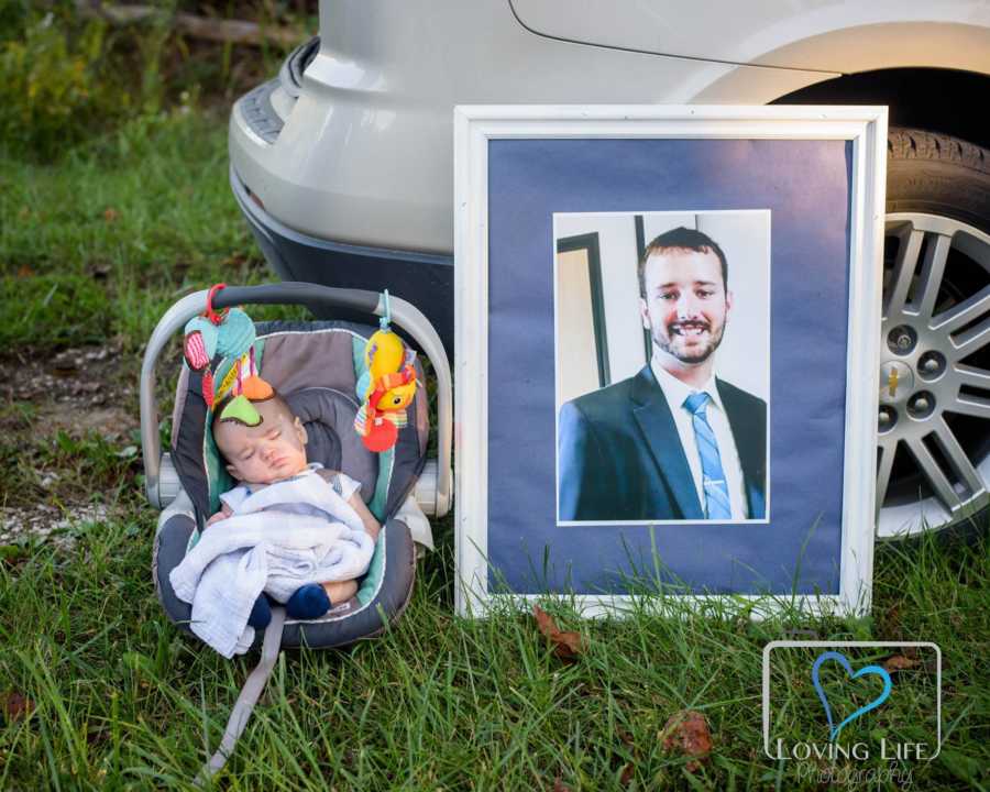 Picture frame of late man rests against car and beside it is man's nephew he never met
