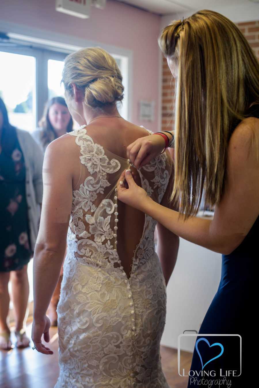Sister buttons up brides dress 