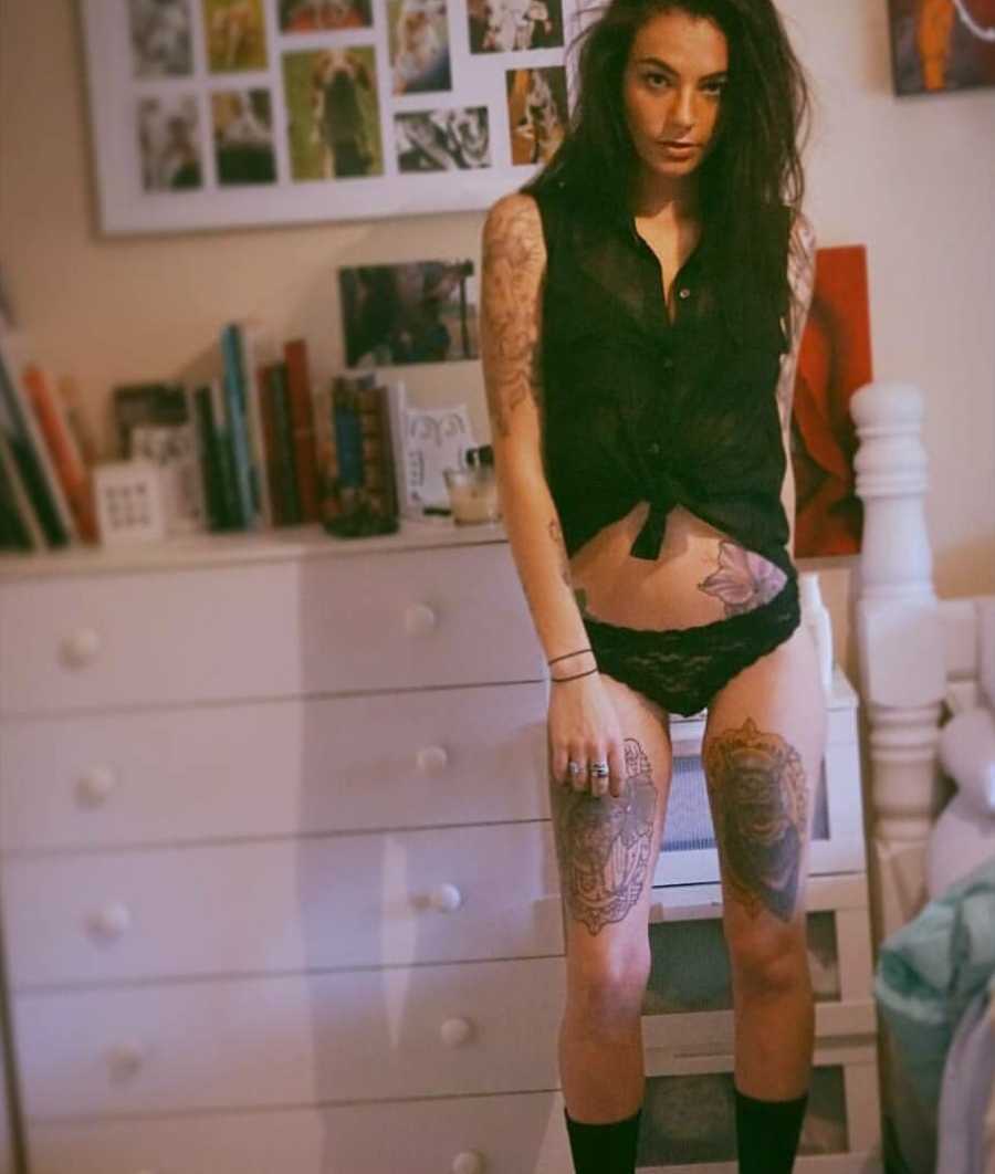 Depressed woman stands in bedroom in shirt and underwear