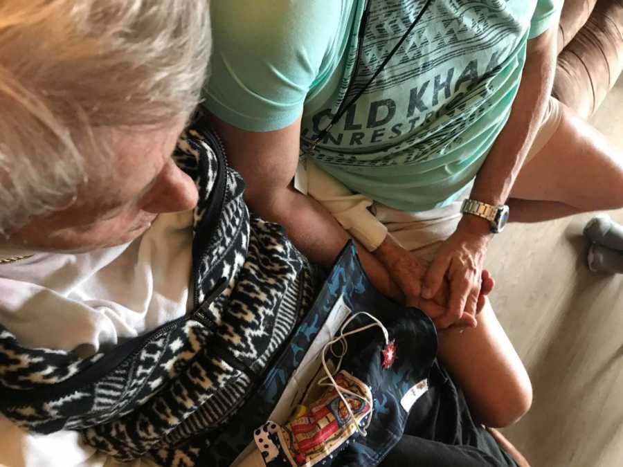 Woman with dementia holds hands with man who stayed at her house when he was a foreign exchange student