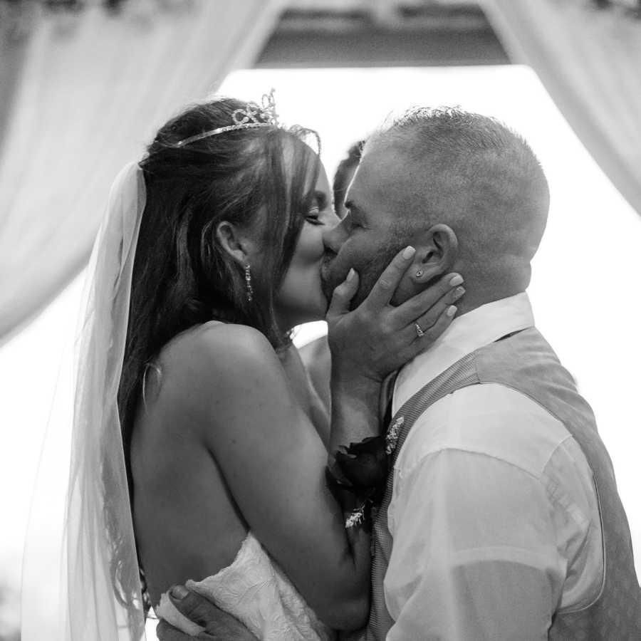 Bride and groom share first kiss at altar