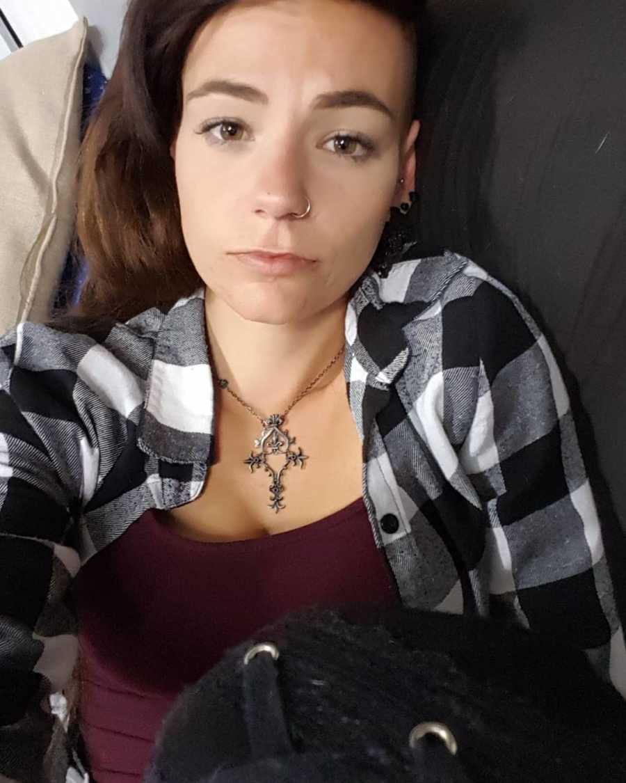 Woman with Bipolar Disorder, Borderline Personality Disorder, Anxiety and Premenstrual Dysphoric Disorder takes selfie on couch