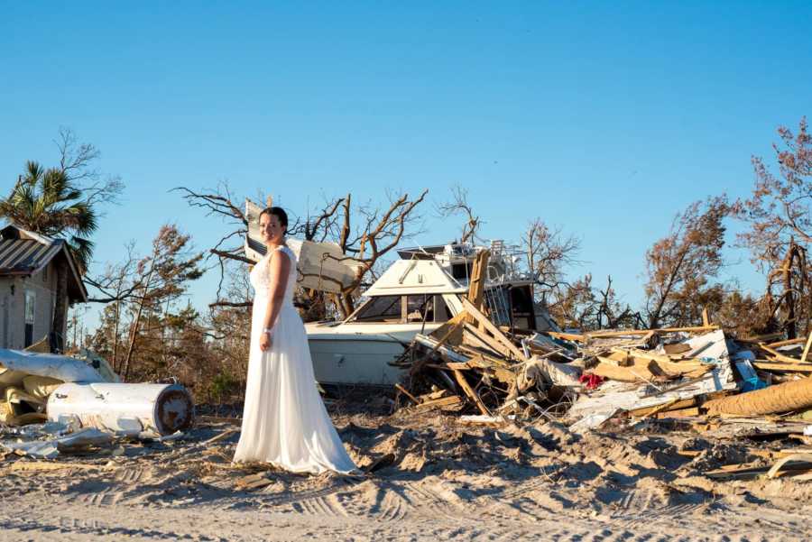 Bride stands beside destruction from Hurricane Michael
