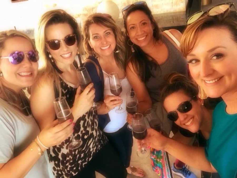 Group of women smiling in selfie holding champagne