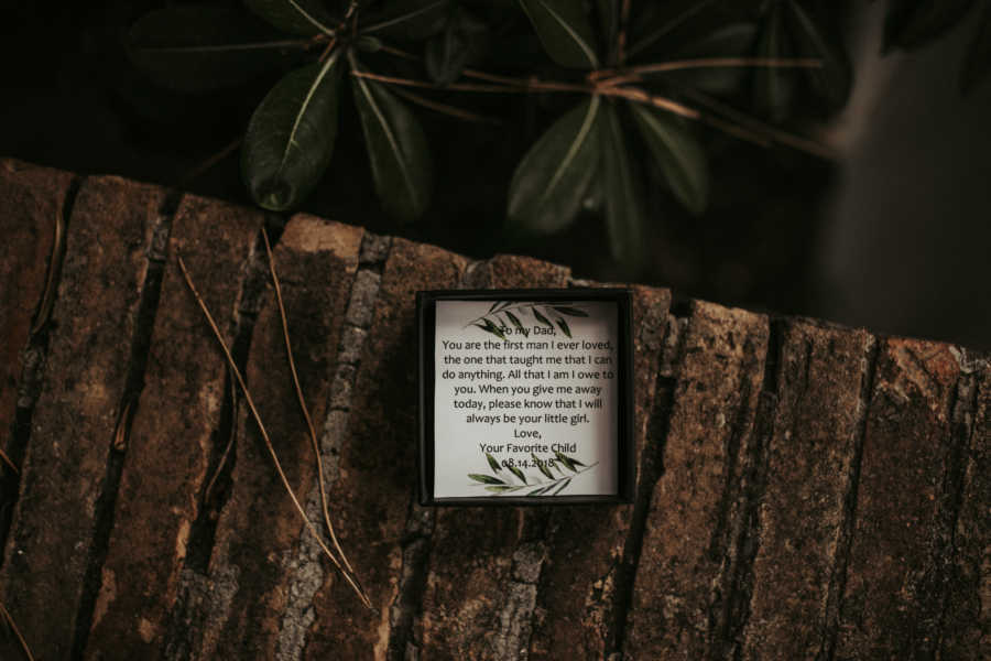 Aerial view of frame with note inside for father from daughter on her wedding day