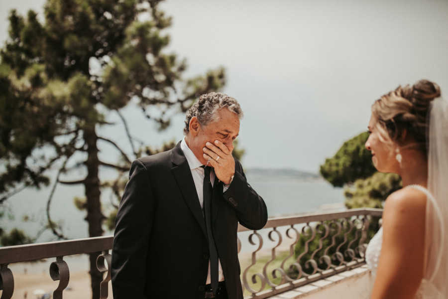 Father cries as he looks at daughter in wedding dress