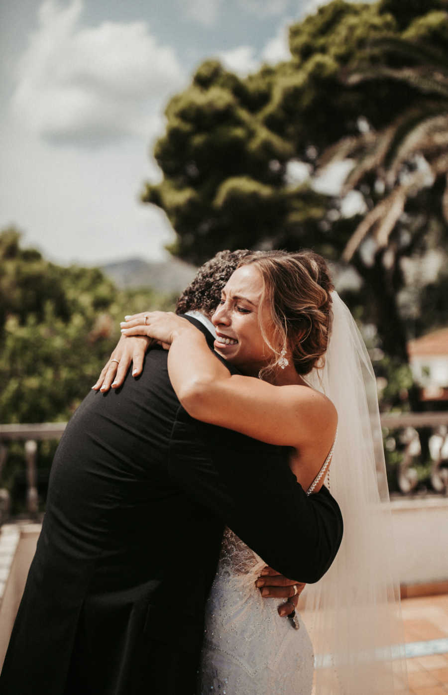 Bride cries as she hugs her father