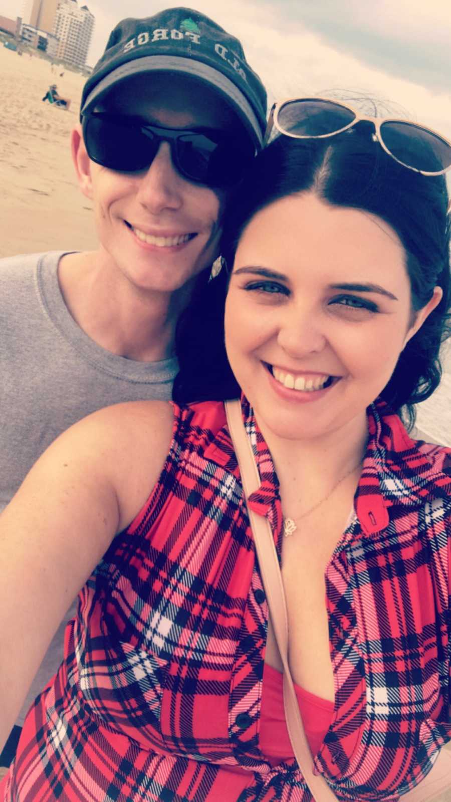 Girlfriend and boyfriend smile in selfie on beach