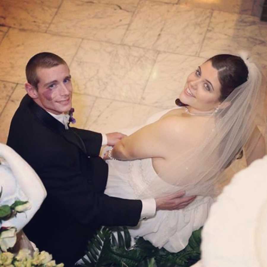 Groom and bride with PCOS look back smiling on wedding day