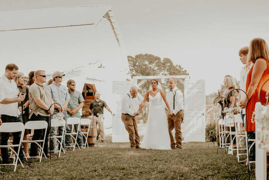 Woman who was paralyzed from waist down walks down aisle with help from two men at outdoor wedding