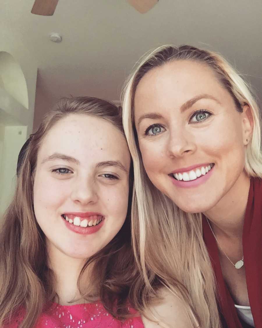 Woman smiles in selfie with her teen daughter