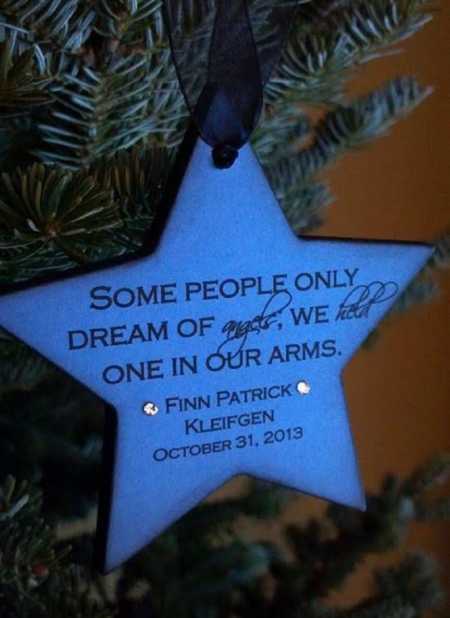 Blue star ornament that says, "Some people only dream of angels, we hold on in our arms"