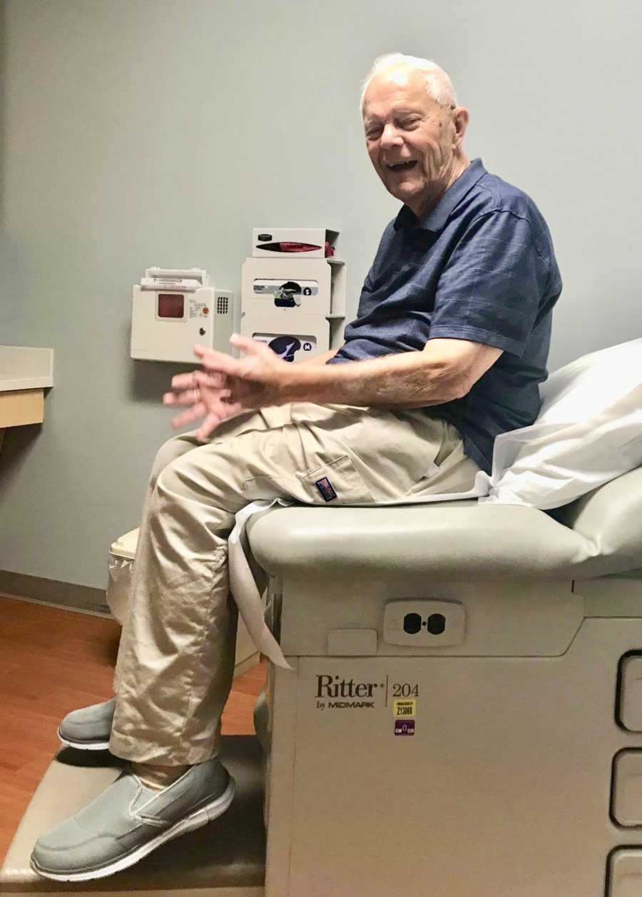 89 year old man sits in doctor's office smiling
