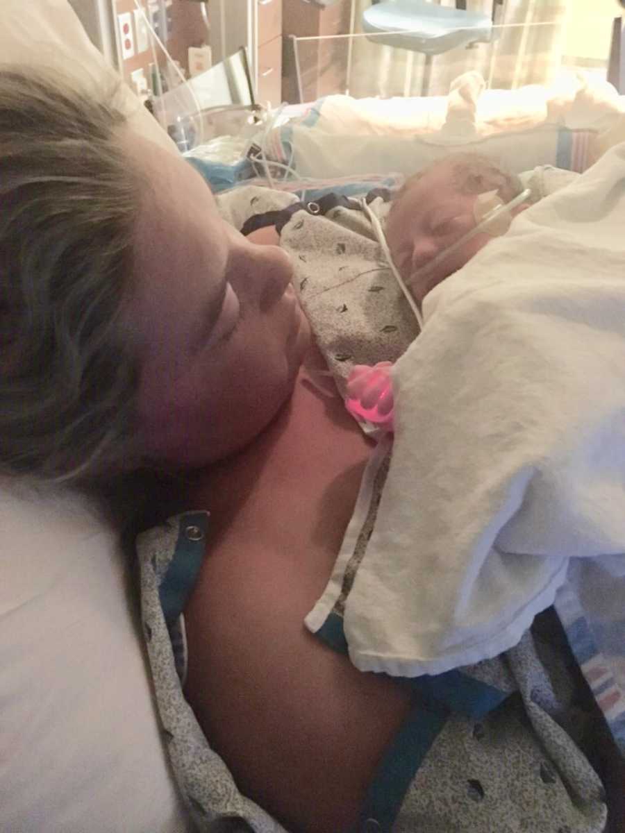 Mother with HELLP looks down at newborn laying on her chest that had to be rushed to NICU